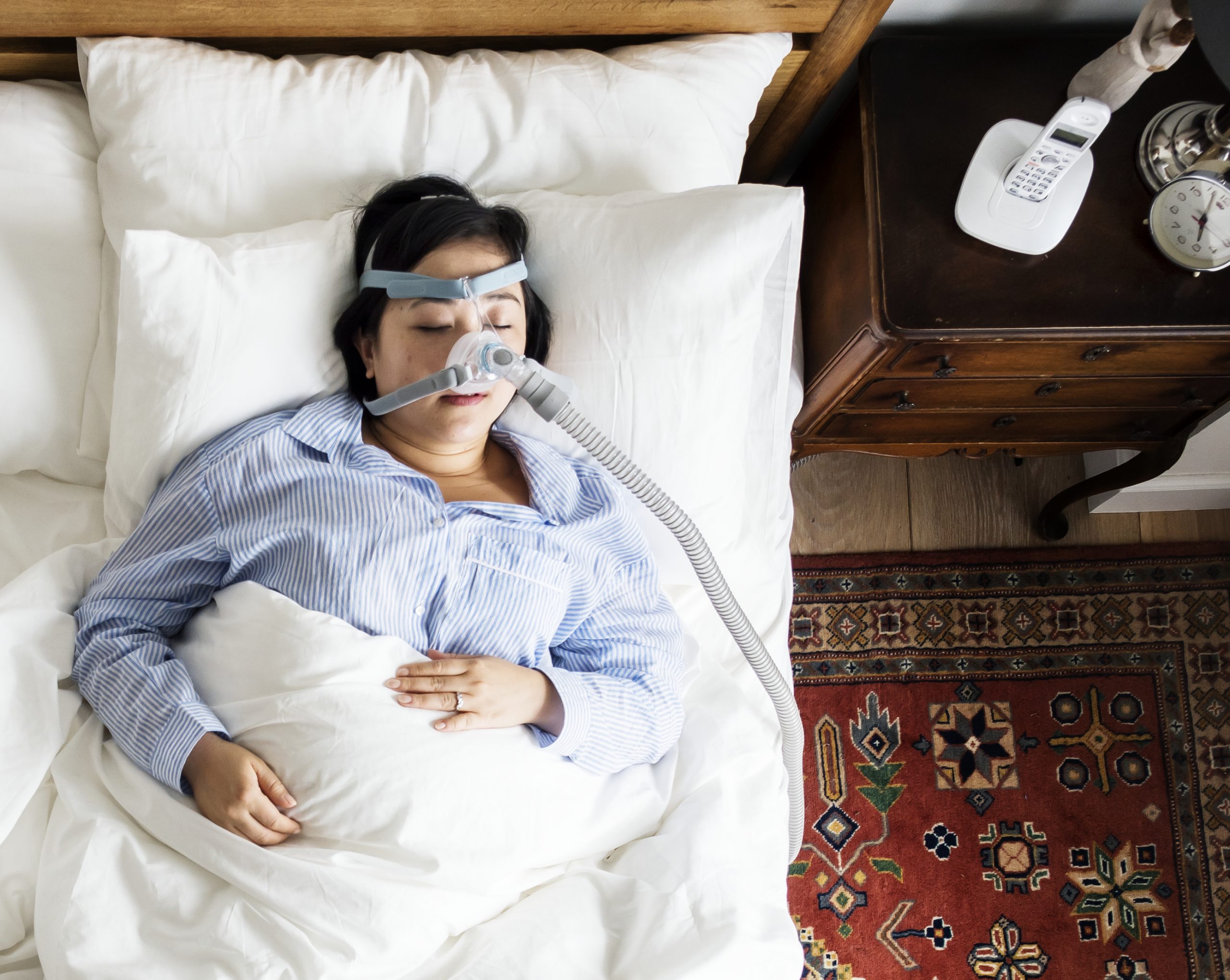Woman sleeping with an anti-snoring mask